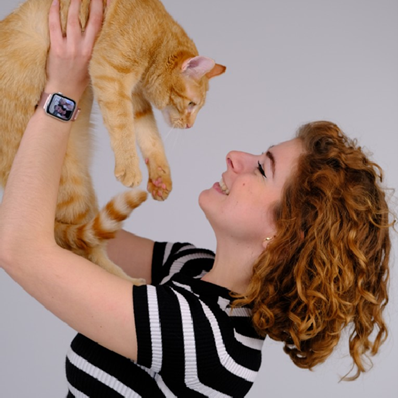 Une étudiante de Supveto Rouen sourit en soulevant son chat roux